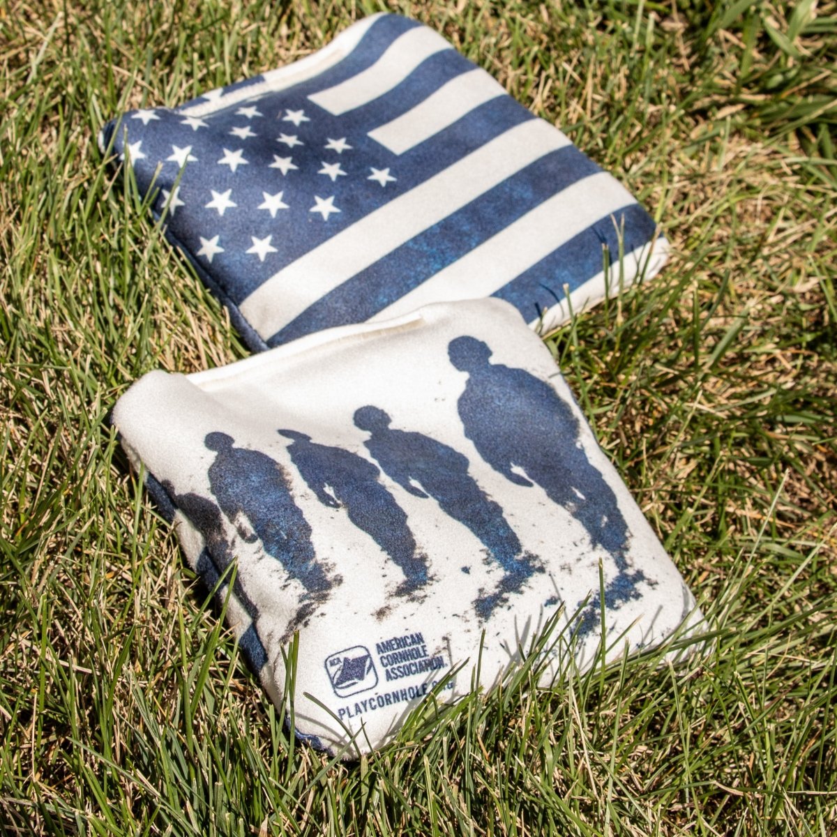 American Flag Red Lock Shot Cornhole Bag resting on grass before gameplay, designed for control, blocking, and keeping more bags on the
board.
#color_blue