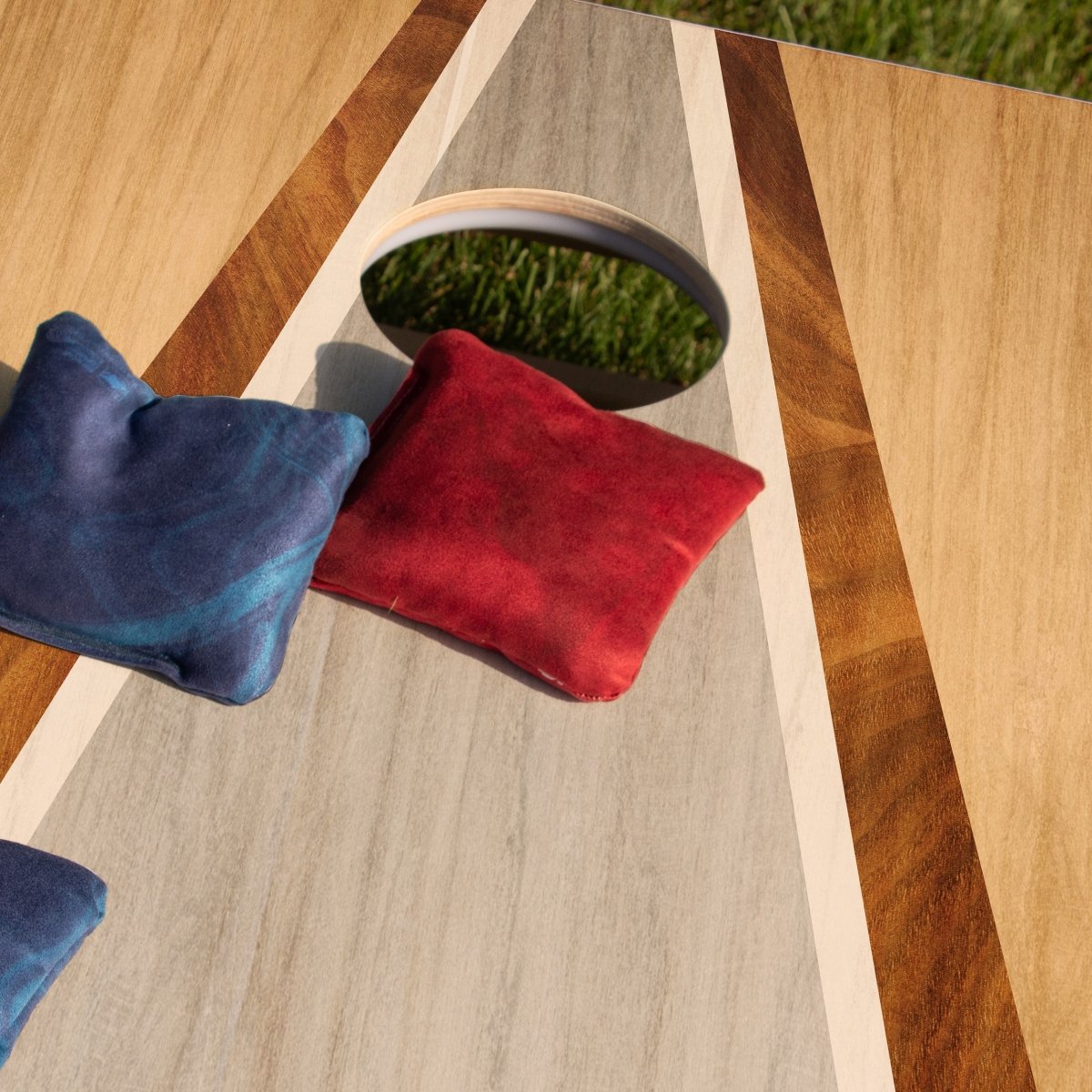 Classic Red Lock Shot Cornhole Bags resting on an ACA cornhole board before gameplay, designed for control, blocking, and keeping more bags on the board.