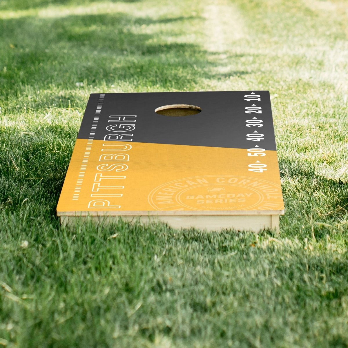 Premium wooden cornhole board with game day stadium graphics.